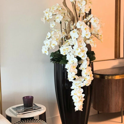San Jose Vase in glossy black with hanging yellow orchids The New Garden 